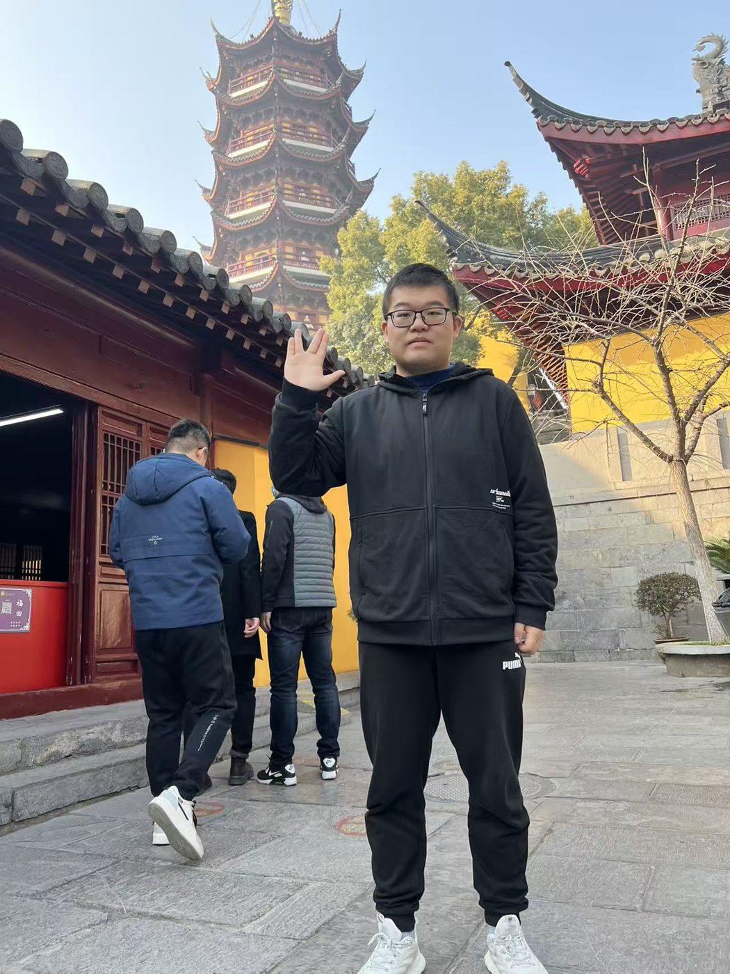 Nathan at a temple with a pagoda behind